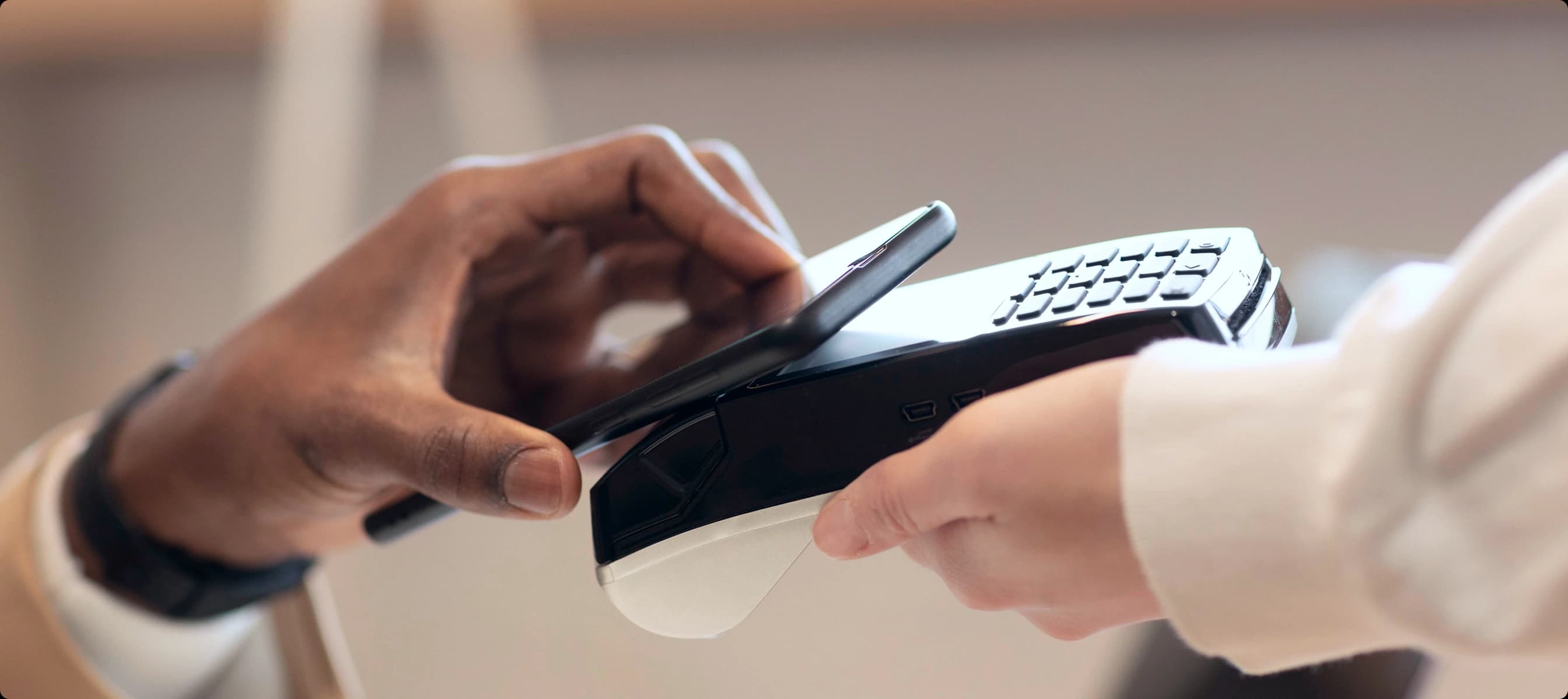 Customer completing a contactless payment at a point-of-sale terminal